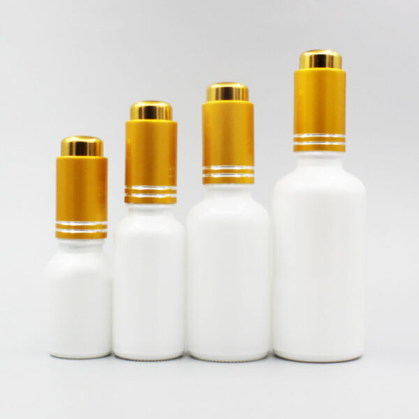 white glass bottles with matte gold droppers